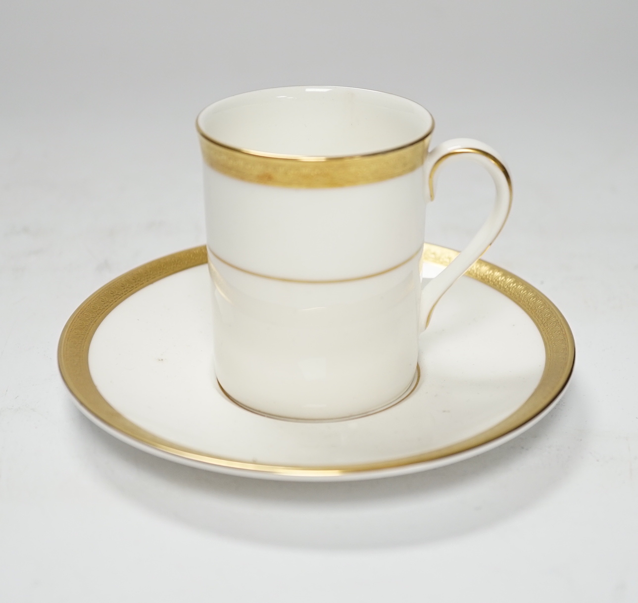 A cased Royal Doulton Royal gold pattern set of coffee cans and saucers
